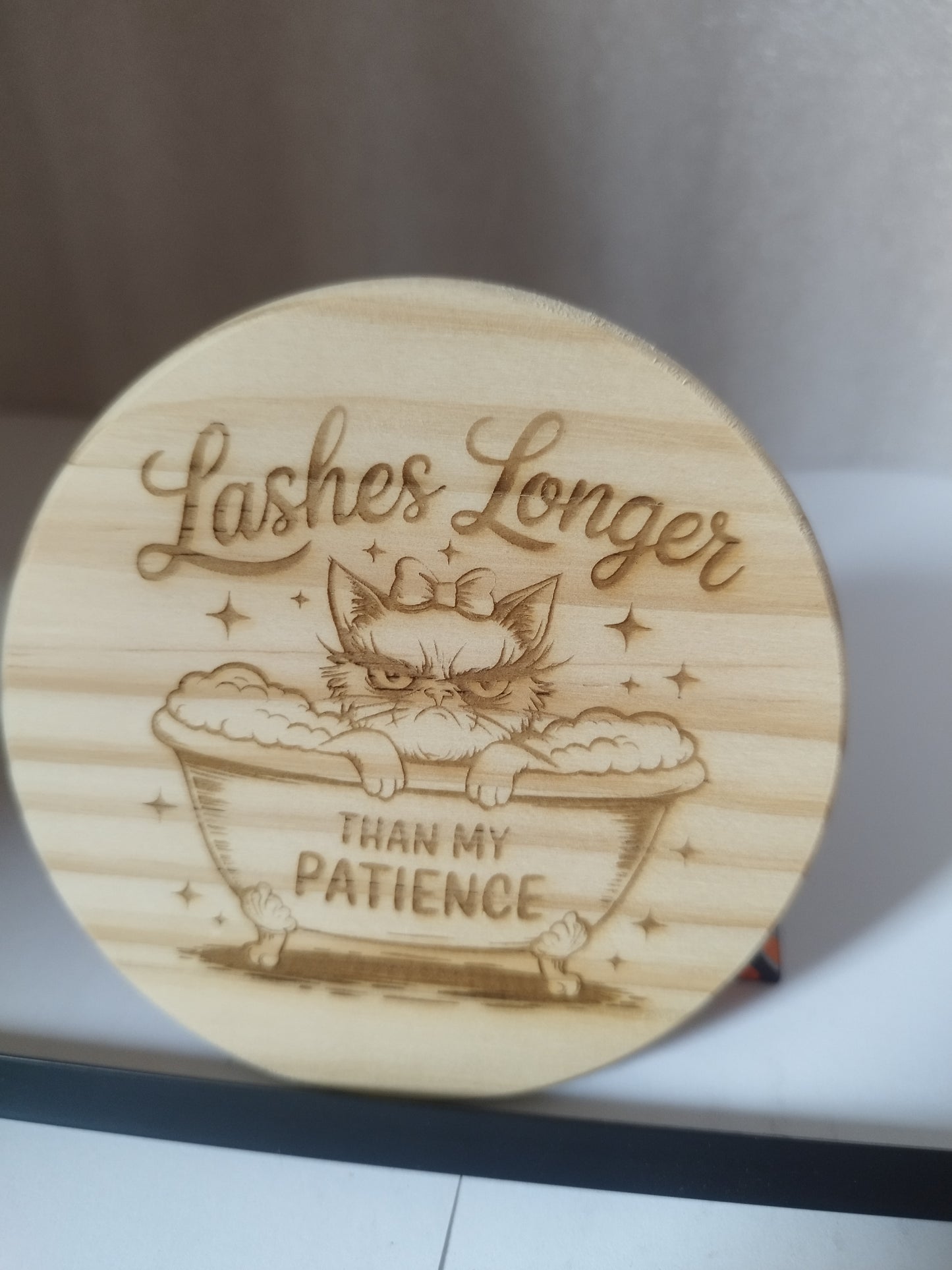 Lashes engraved wood coaster